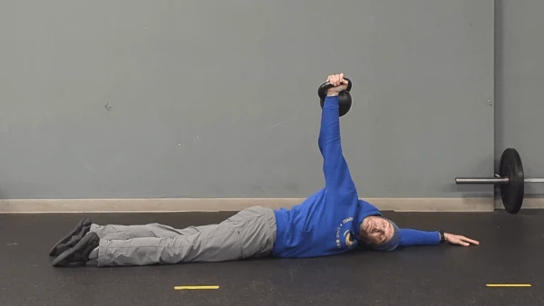 Coach Ryan demonstrates an advanced kettlebell arm bar—rotating almost completely face-down and resting the head on the floor.