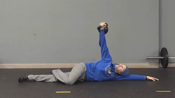 Coach Ryan demonstrates the basic end position of the kettlebell arm bar—with stacked shoulders and hips.