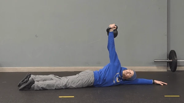 Coach Ryan demonstrates an intermediate kettlebell arm bar—rotating the hips downward.