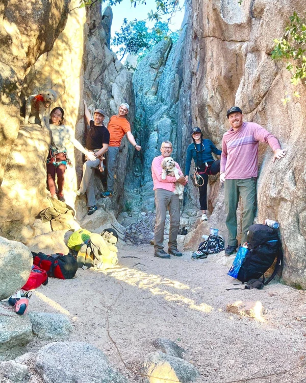 Coach Ryan with his brother, sister-in-law, and some friends hanging on an actual rock wall after a day of climbing.