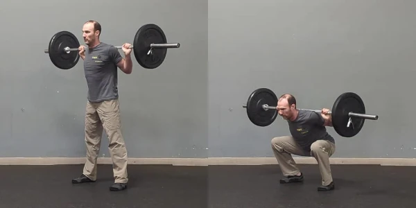 Coach Ryan demonstrates a barbell back squat.