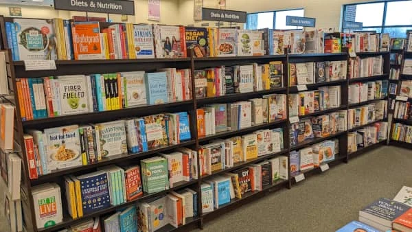A row of five shelves of books in the nutrition section of a local Barnes & Noble
