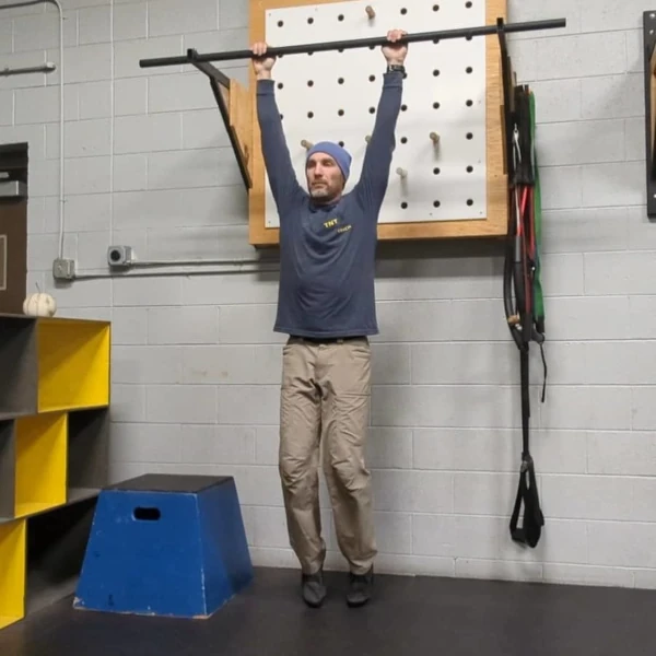 Coach Ryan demonstrates a supported dead hang.
