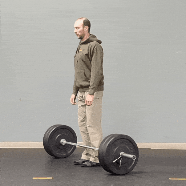Coach Ryan demonstrates a barbell deadlift after first wedging to set up.