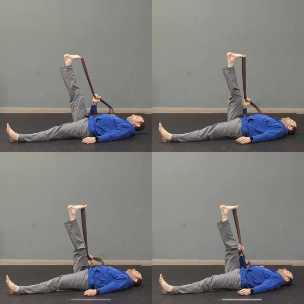 Coach Ryan demonstrates a belt-assisted adjacent-toes stretch.