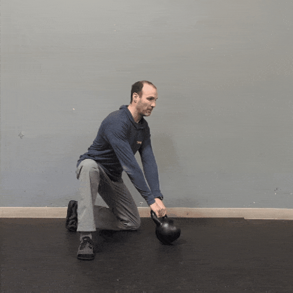 Coach Ryan demonstrates half-kneeling swings.