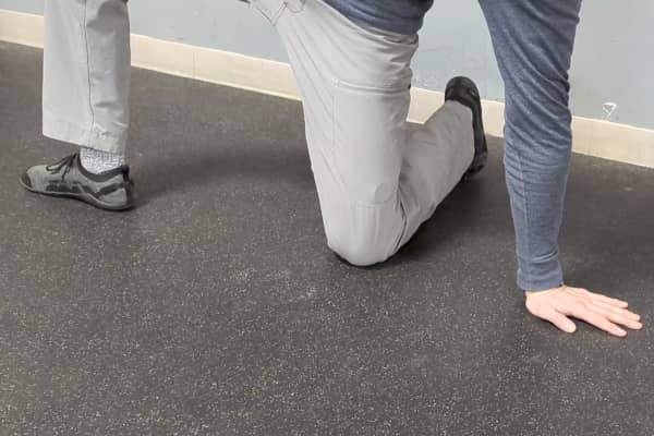 A close-up view of a not-so-good position of the hand and legs in the half-kneeling portion of the getup—the hand is in a line with the foot and knee instead of at a right angle.