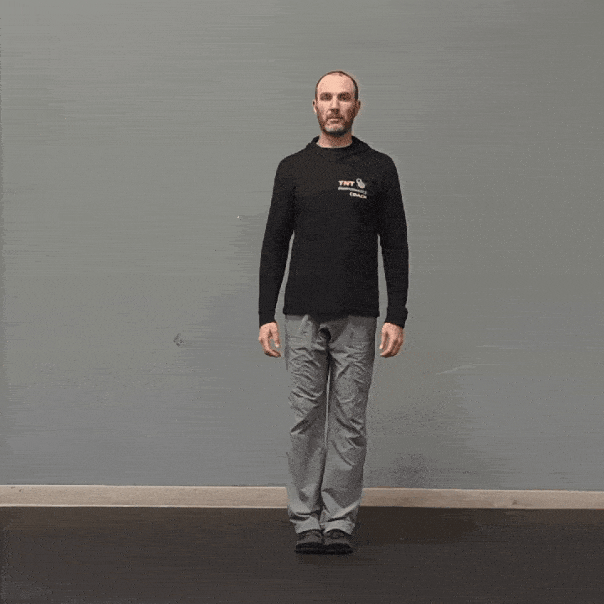 Coach Ryan demonstrates leg movement in the frontal plane with hip abduction and adduction.