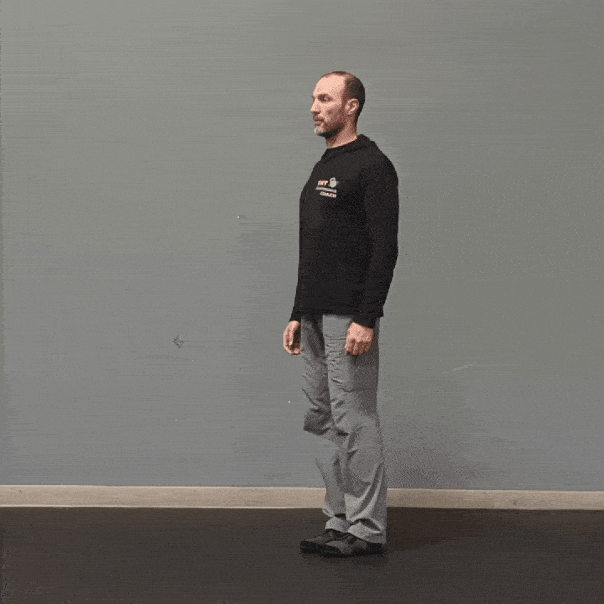 Coach Ryan demonstrates leg movement in the sagittal plane with hip flexion and extension.