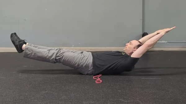 Coach Ryan demonstrates a good—back is flat—hollow position.