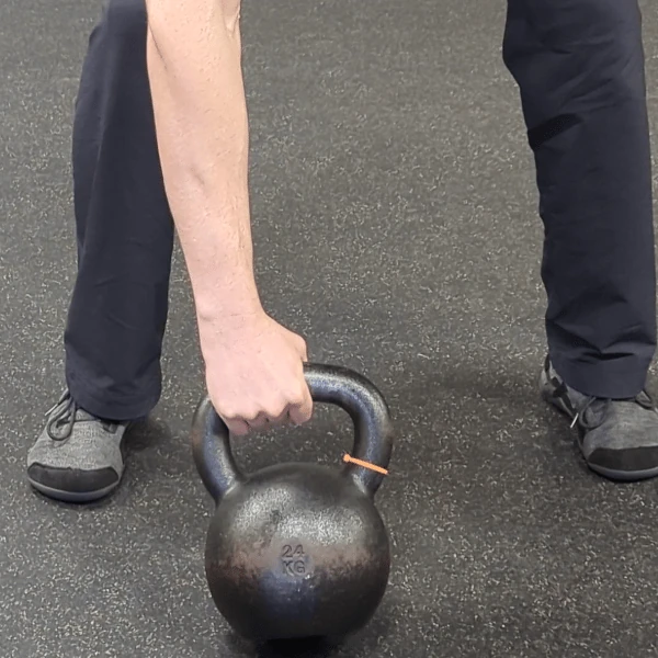 Coach Ryan shows the kettlebell hand's placement in the lateral grip (pronated view).