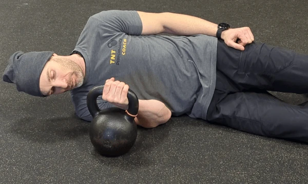 Coach Ryan shows the kettlebell hand's placement in the lateral grip (supinated view).