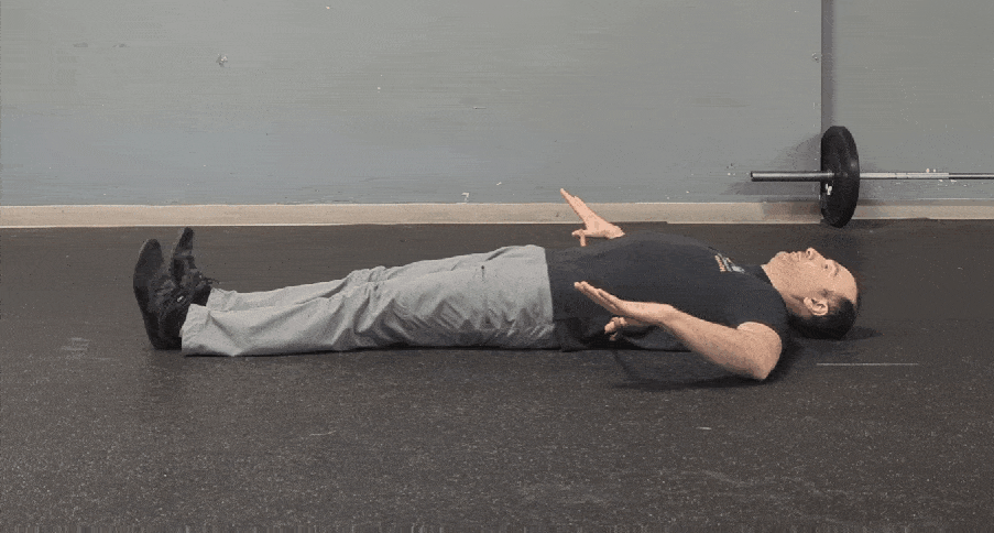 Coach Ryan demonstrates a normal arched lumbar spine position.