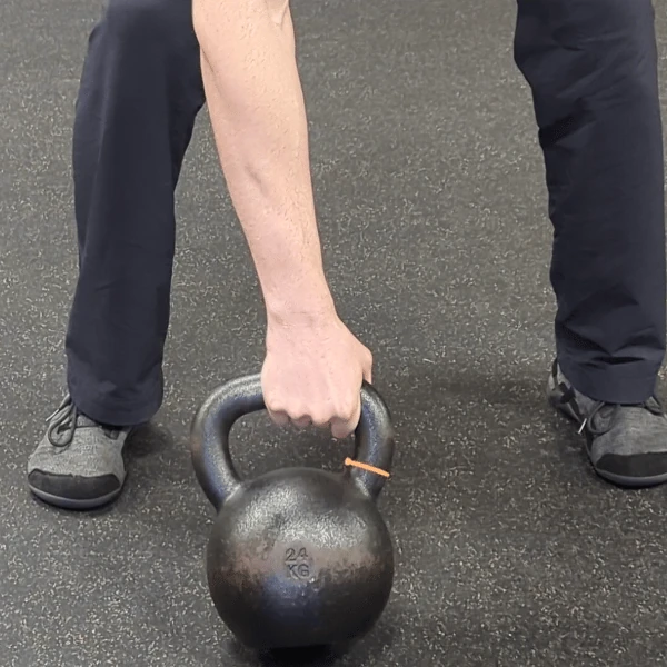 Coach Ryan shows the kettlebell hand's placement in the medial grip (pronated view).