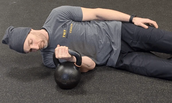 Coach Ryan shows the kettlebell hand's placement in the medial grip (supinated view).