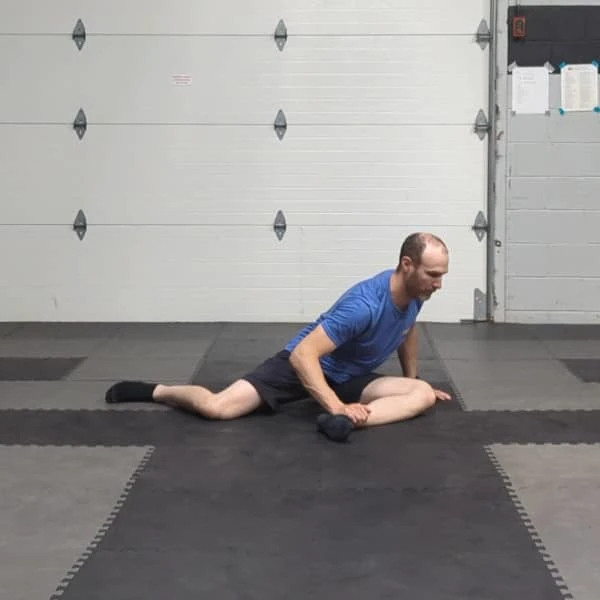 Coach Ryan demonstrates the 90/90 stretch for the glutes.