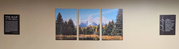 A wall in Coach Ryan's office which displays a quote from Teddy Roosevelt's "The Man in the Arena" speech, a three-panel picture of Grand Teton, and another leadership quote.