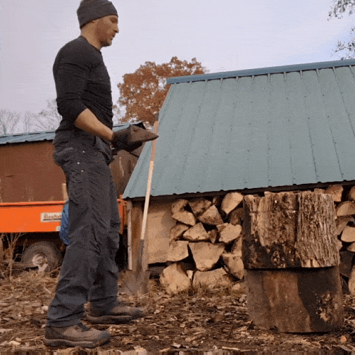 Coach Ryan splits a piece of wood with a single axe swing.