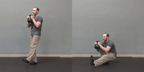 Coach Ryan demonstrates a weighted pistol squat.