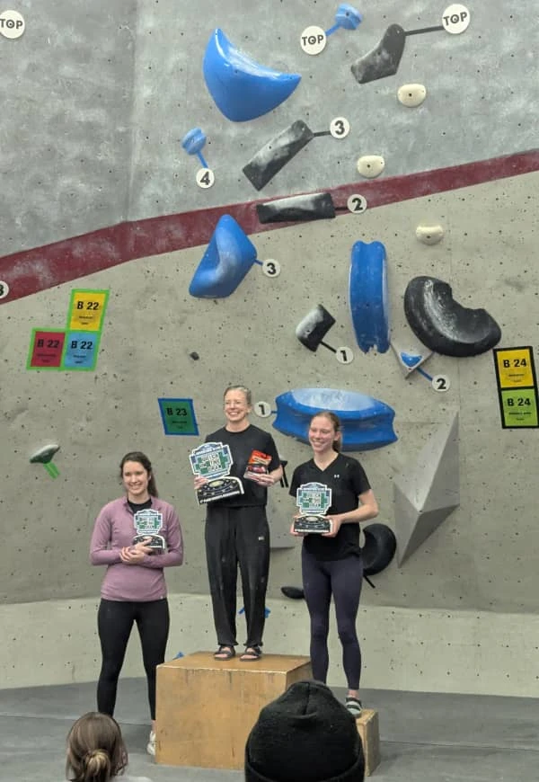 Coach Ryan's climbing partner, Lizzie, stands atop the podium for the women's recreational division.