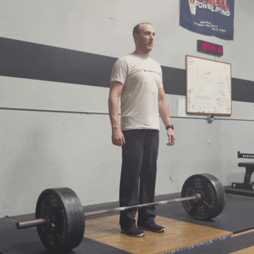 Coach Ryan wedges into his deadlift setup and pulls 415 pounds during a training session