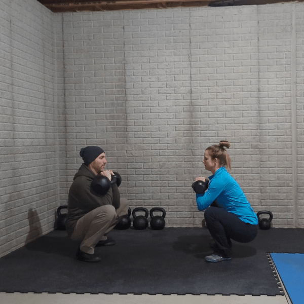 Coach Ryan and his better half, Shannon, do double kettlebell front squats.