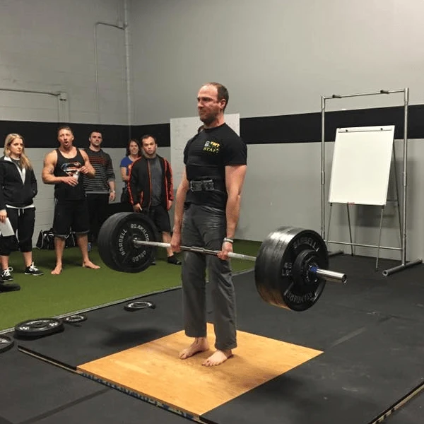 Coach Ryan stands at the top of his PR deadlift attempt.