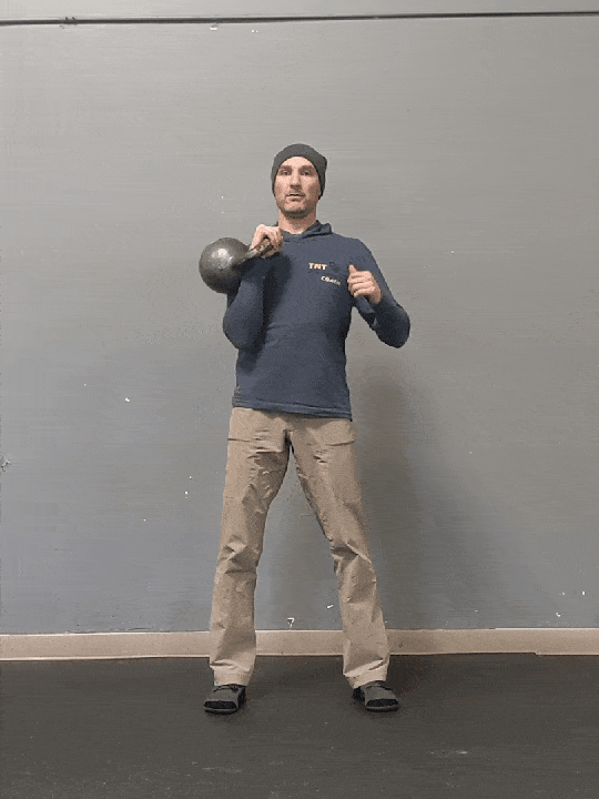 Coach Ryan demonstrates a single kettlebell military press.
