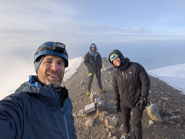 Coach Ryan and two partners stand at the summit of Mt. Rainier.