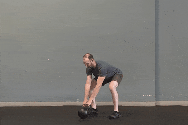 Coach Ryan demonstrates kettlebell swings with an (incorrect) early hinge.