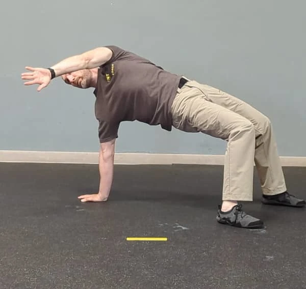 Coach Ryan demonstrates a common T-spine Bridge mistake—too much rotation in the post hand.