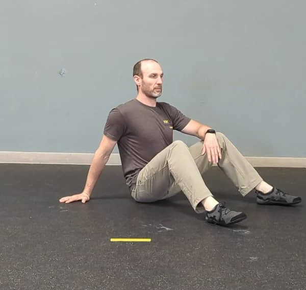 Coach Ryan demonstrates the setup position for the T-spine Bridge.