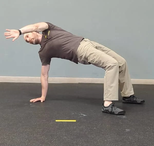 Coach Ryan demonstrates the T-spine Bridge.