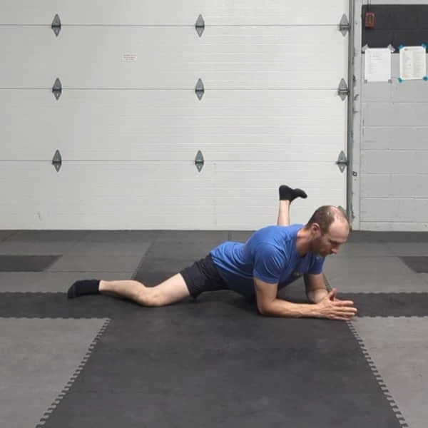 Coach Ryan demonstrates a left leg hip rotation in the Tactical Frog.