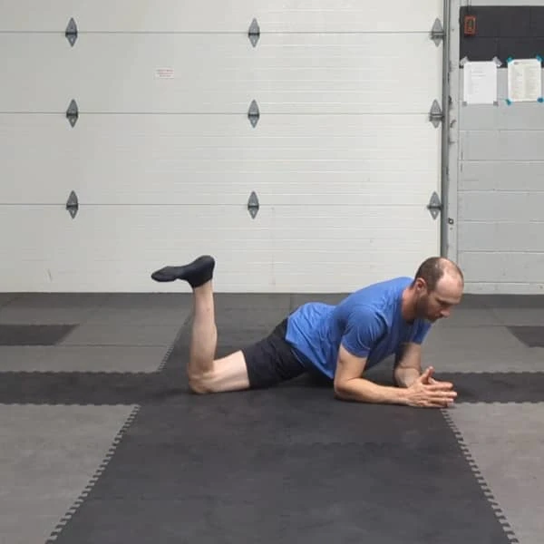 Coach Ryan demonstrates a right leg hip rotation in the Tactical Frog.