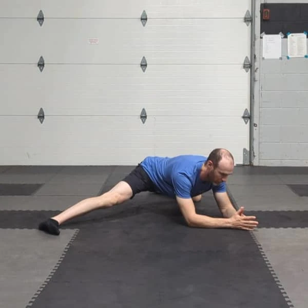 Coach Ryan demonstrates a straight-leg variation of the Tactical Frog on the elbows.