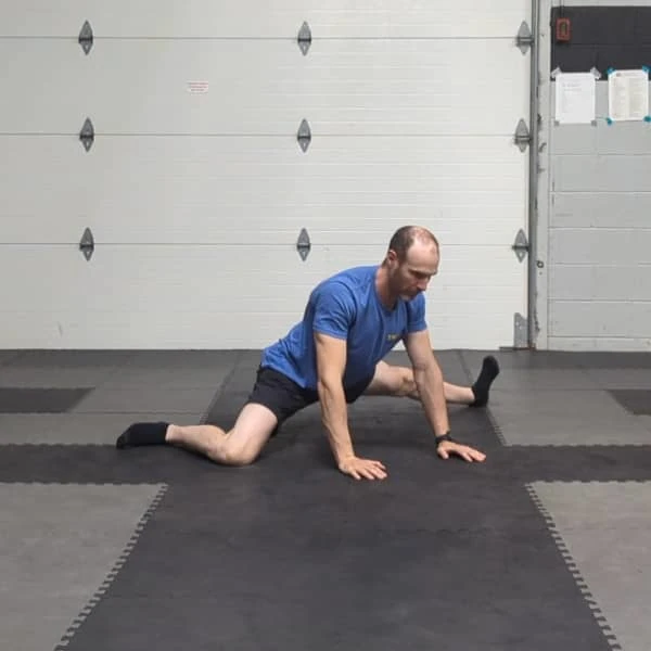 Coach Ryan demonstrates rocking in a straight-leg variation of the Tactical Frog.
