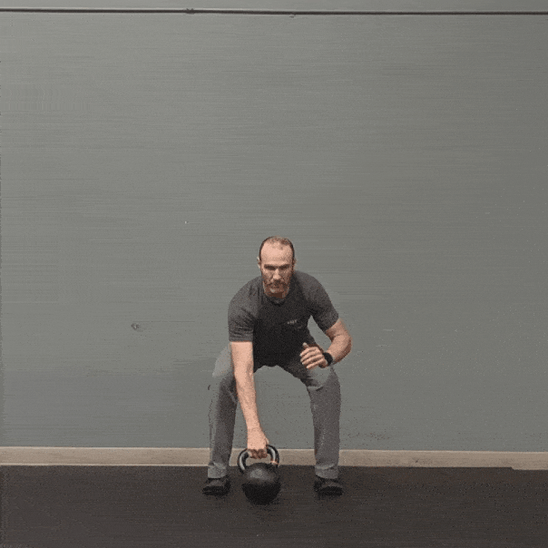 Coach Ryan demonstrates a kettlebell waiter press.