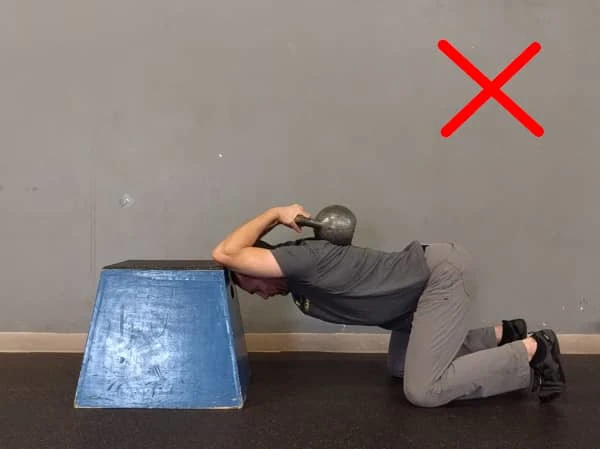 Coach Ryan demonstrates a common mistake on the Weighted Spine Stretch.