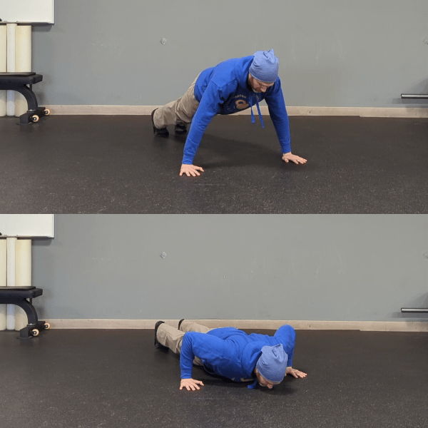 Coach Ryan demonstrates a pushup position with hands wider than his shoulders.